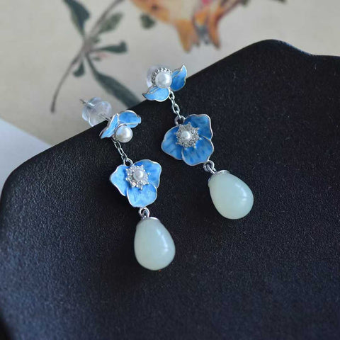 Anting perak sterling 7994#925 dengan liontin bunga magnolia yang dapat dilepas, terbuat dari giok Hetian, desain dua untai. Dimensi giok: 7*10 mm. Harga sudah termasuk ongkos kirim dan pajak.