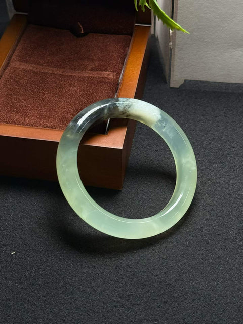 Gelang giok Xiuyan alami dan tembus cahaya ini berukuran sekitar 56,5 x 12,3 x 9,3 mm. Semua batu terbentuk secara alami. Harga sudah termasuk ongkos kirim dan pajak.