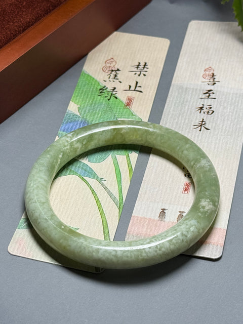 Gelang giok Xiuyan alami dengan desain bunga yang halus dan elegan. Perkiraan dimensi: 60-10,3-10,3 mm. Semua batu terbentuk secara alami. Termasuk ongkos kirim dan pajak.