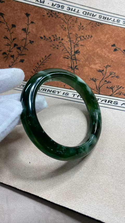 Gelang giok Xiuyan yang indah, berwarna hijau pekat dengan zamrud yang berkilauan, melambangkan kekayaan dan kemakmuran seumur hidup. Diameter dalam: 60 mm, lebar tepi: 12,7 mm. Semua batu terbentuk secara alami. Termasuk ongkos kirim dan pajak.