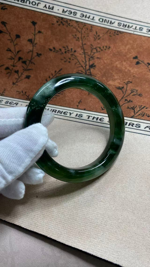 Gelang giok Xiuyan yang indah, berwarna hijau pekat dengan zamrud yang berkilauan, melambangkan kekayaan dan kemakmuran seumur hidup. Diameter dalam: 60 mm, lebar tepi: 12,7 mm. Semua batu terbentuk secara alami. Termasuk ongkos kirim dan pajak.