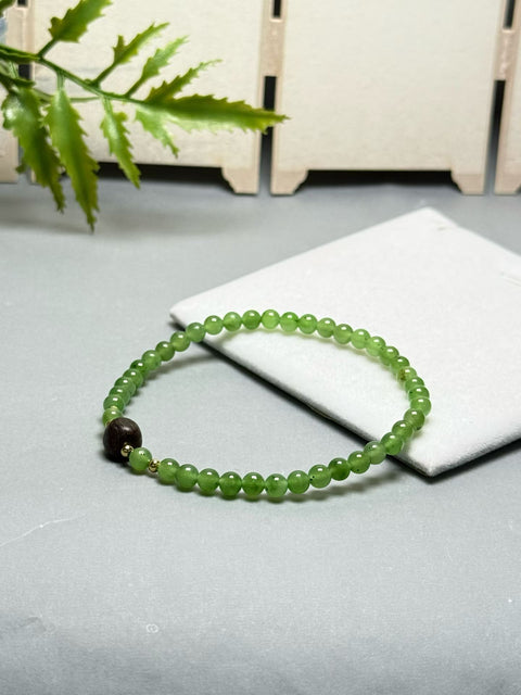 Gelang giok Hetian ini memiliki warna hijau hangat dan berkilau, serta dihiasi dengan aksen kayu gaharu. Desainnya yang sederhana membuatnya cocok untuk berbagai kesempatan. Ukuran perkiraan: 4 mm. Harga sudah termasuk ongkos kirim dan pajak.