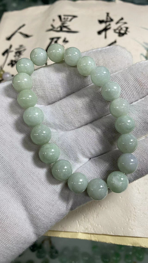 Gelang karet jadeite grade A Ukuran 10mm Batu giok adalah batu giok yang halus dan hangat dengan pola yang indah.