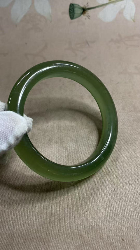 Gelang giok Xiuyan yang indah, berwarna hijau penuh dengan zamrud yang mengambang, melambangkan kekayaan dan kemakmuran seumur hidup. Diameter: 64,2 mm, lebar tepi: 12 mm. Semua batu terbentuk secara alami. Biaya pengiriman dan pajak sudah termasuk.